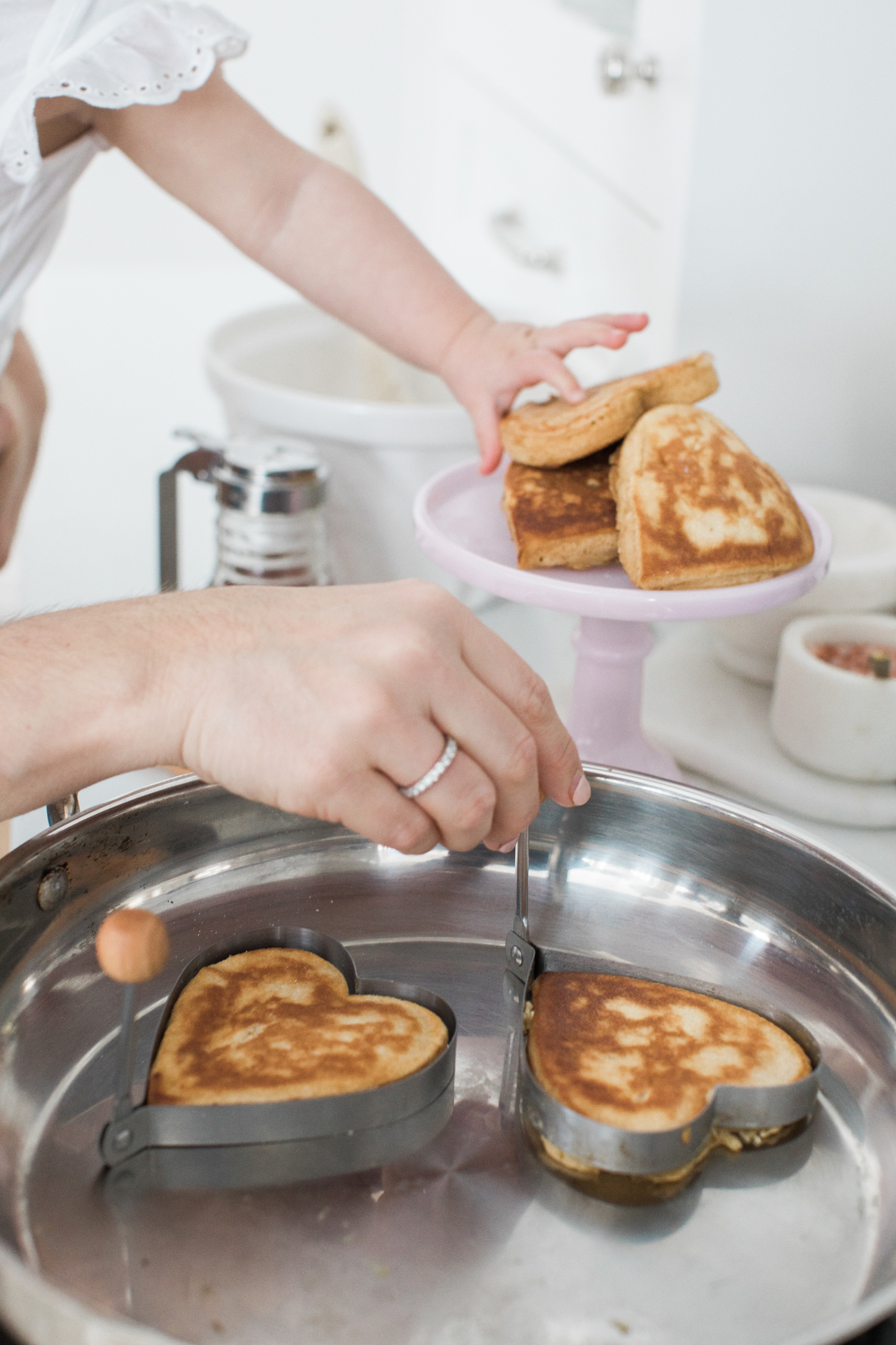 Mother daughter making pancakes