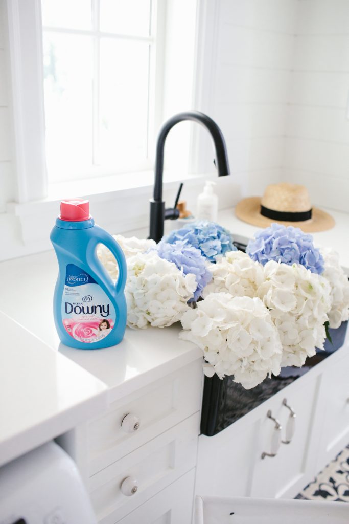 Bottle of Downy fabric conditioner in Monika's laundry room