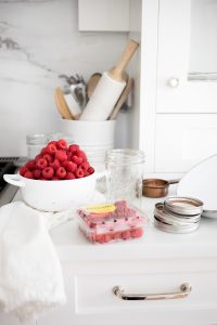 canning supplies and washed raspberries