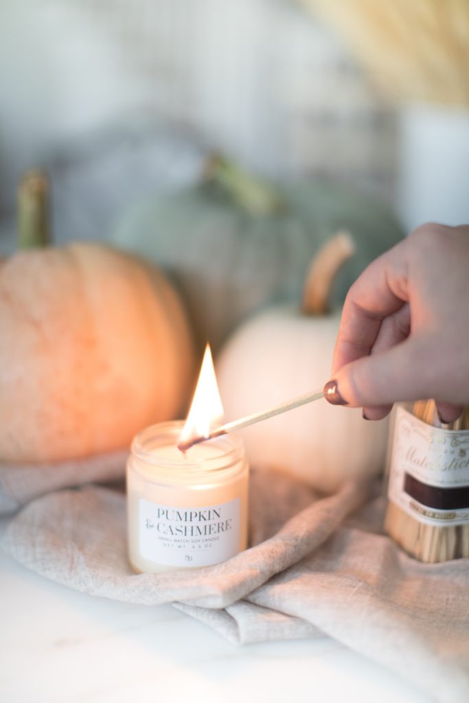 lighting candle with match