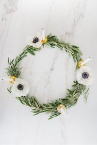 olive branch wreath with candles and flowers