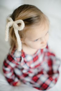 white yarn bow in hair