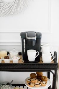 keurig coffee machine, white mugs and beverage toppings