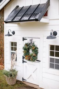 White playhouse with christmas wreath