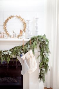 garland on mantel, stockings and glitter homes