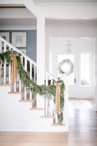 garland on banister with muted toned bows