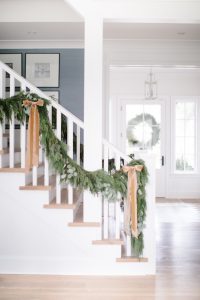 holiday garland with bows entryway