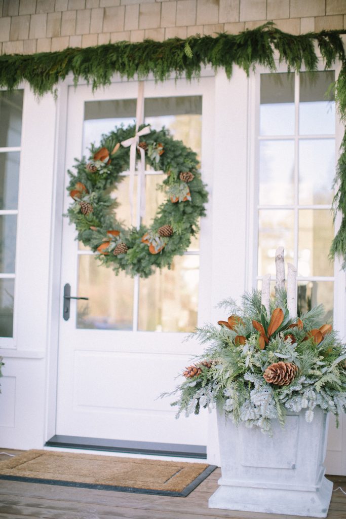 front door with cedar rope, winter planter box and wreath