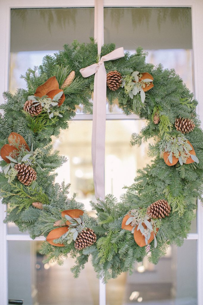 wreath with bow and magnolia on front door