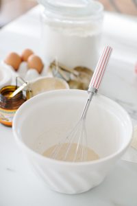 bowl with cream and yeast and whisk