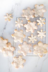 snowflake cookies on cooling rack on mabel countertop