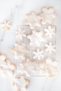 small and large snowflake cookies on marble