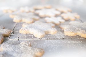 close up of snowflake cookies dusted with icing sugar