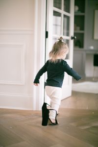 little girl in moms heels