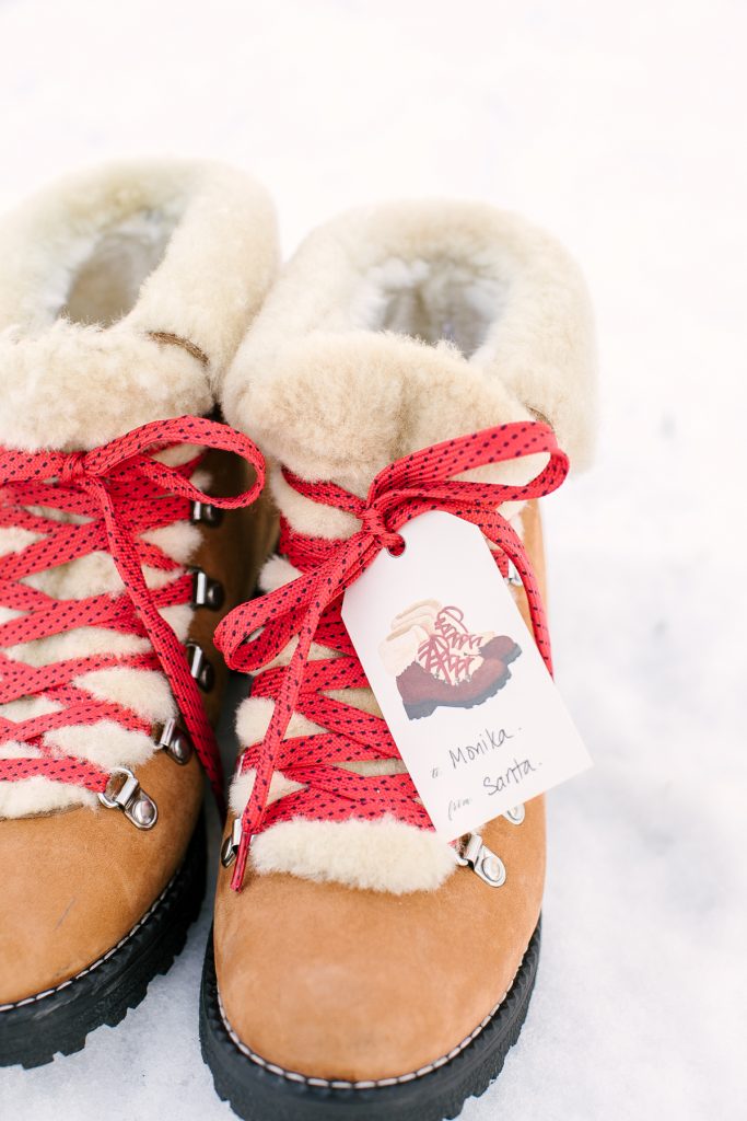 Boots in snow with red laces and matching gift tag