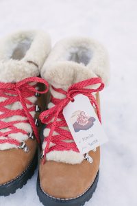Gifts in snow with red laces and gift tag