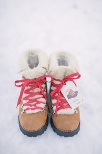 boots is snow with gift tag and red laces