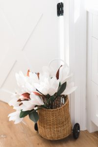 small wicker basket with paper magnolia flowers