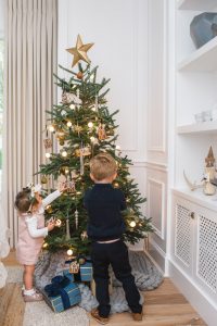 little boy and girl decorating tree