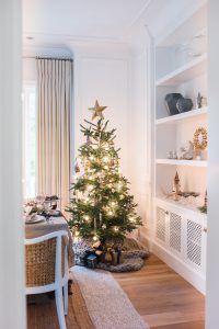small christmas tree in white dinning room corner