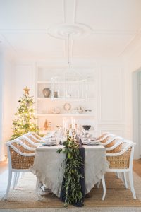 white dinning room set up with christmas table