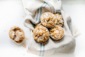 over head of muffins in cream tin with french linen napkin