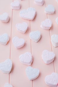 heart shaped marshmallows on pink board