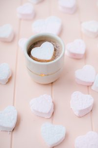 heart marshmallows on pink cutting board