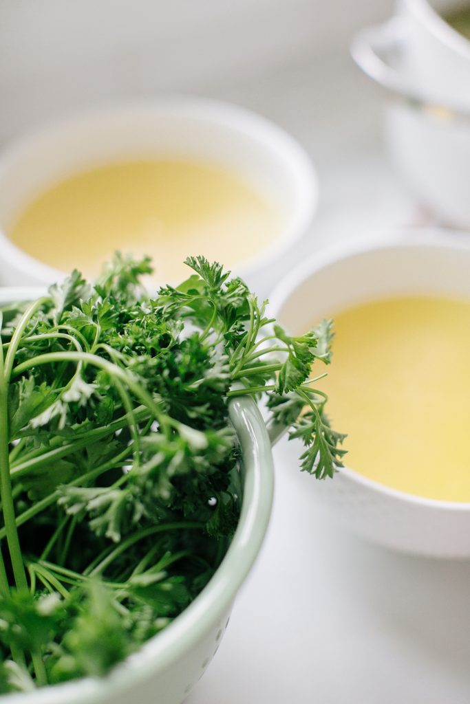 chicken broth in bowls, bowl of parsley