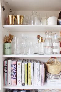 inside kitchen cabinet cookbooks and bar tools