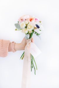 Hand holding bouquet of flowers