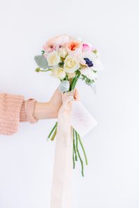 Hand holding bouquet of flowers