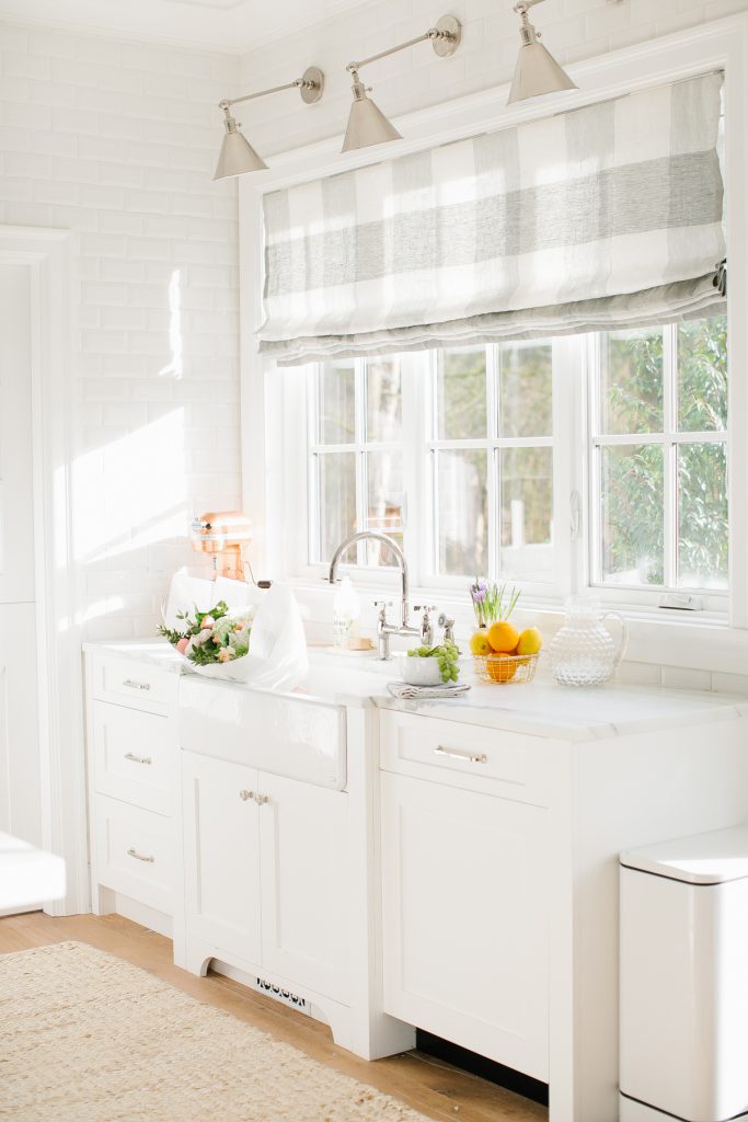 airy and bright kitchen window sink with roman blind