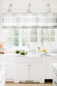 airy white kitchen window sink with buffalo check roman blind