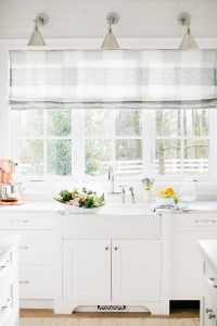 stunning white kitchen with kitchen sink and buffalo check roman blind on window
