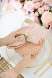 setting table with pink blush napkins