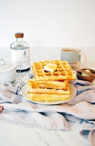 waffels staked with maple syrup on the side