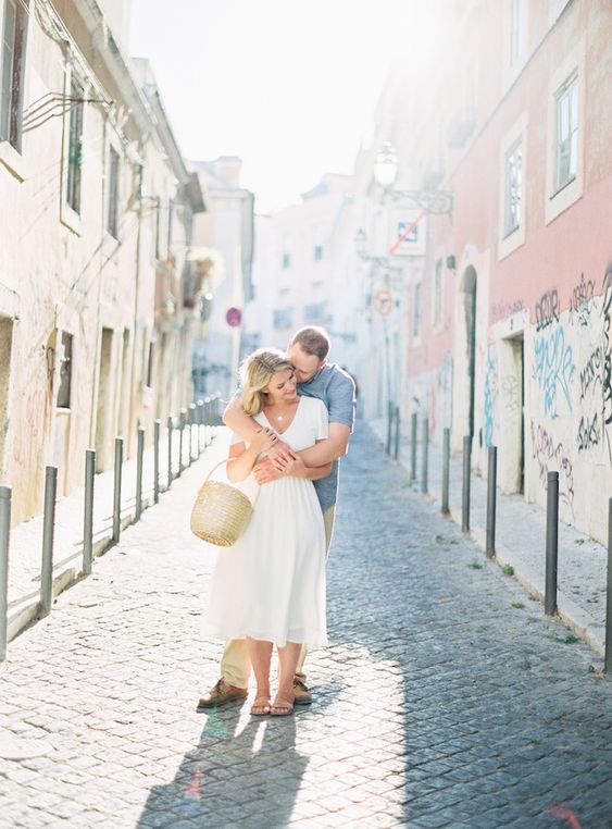 couple kissing on cobblestone streets europe