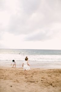 little boy and girl running on Hawaiian beach