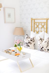 White airy guest room with breakfast in bed
