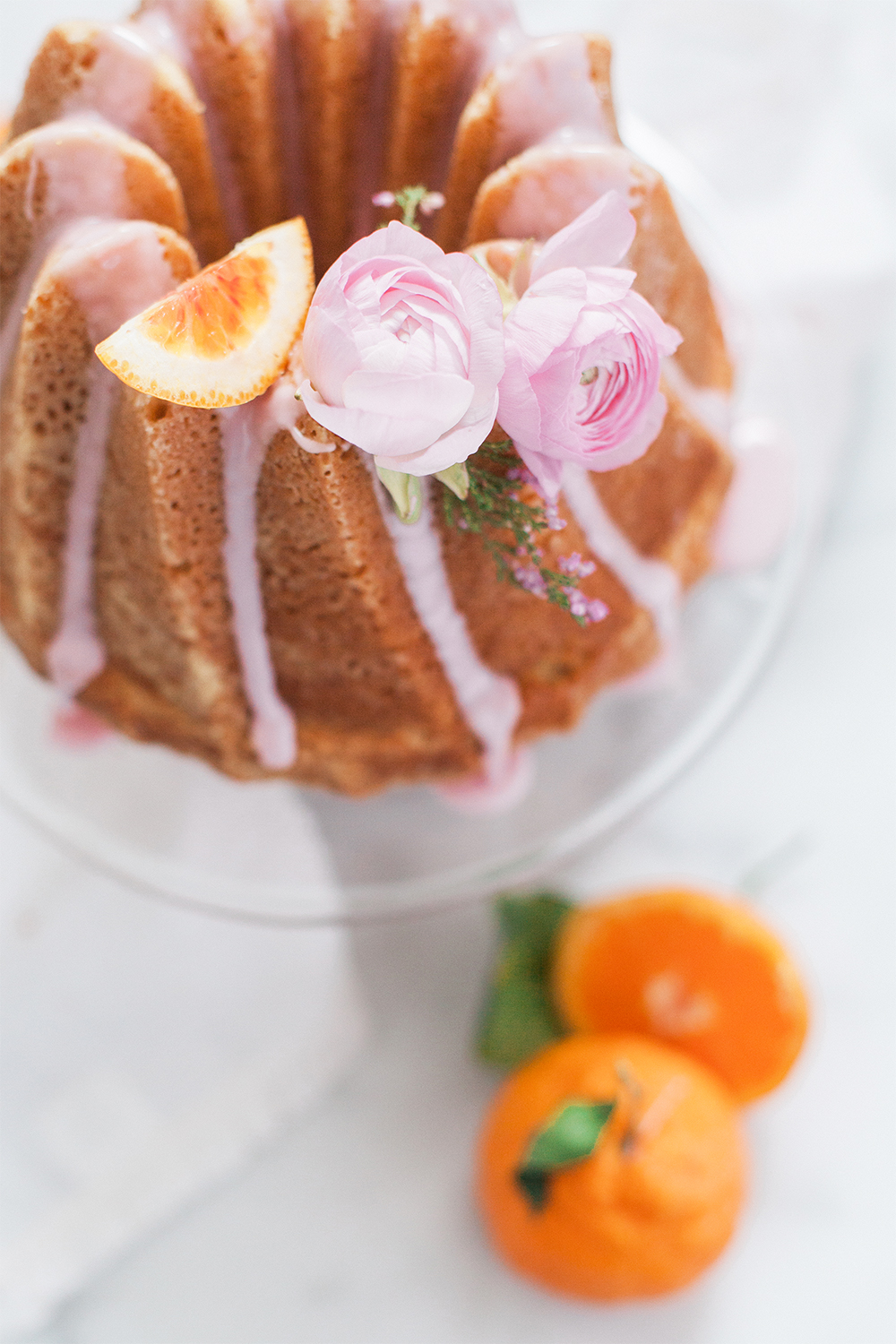 bunt cake with flowers and pink citrus glaze