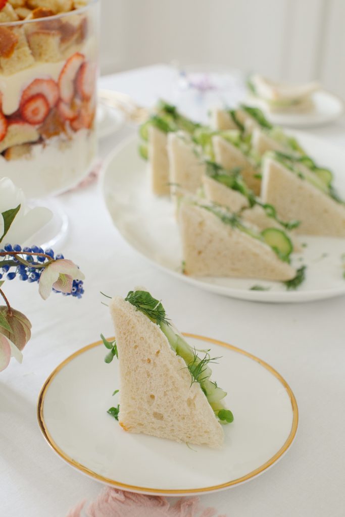 cucumber sandwhich on gold rimmed plate