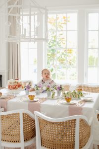 little girl eating strawberry at dinning room table
