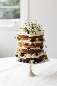 layered naked cake with small daisies