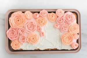 sheet cake in rose gold pan with buttercream roses