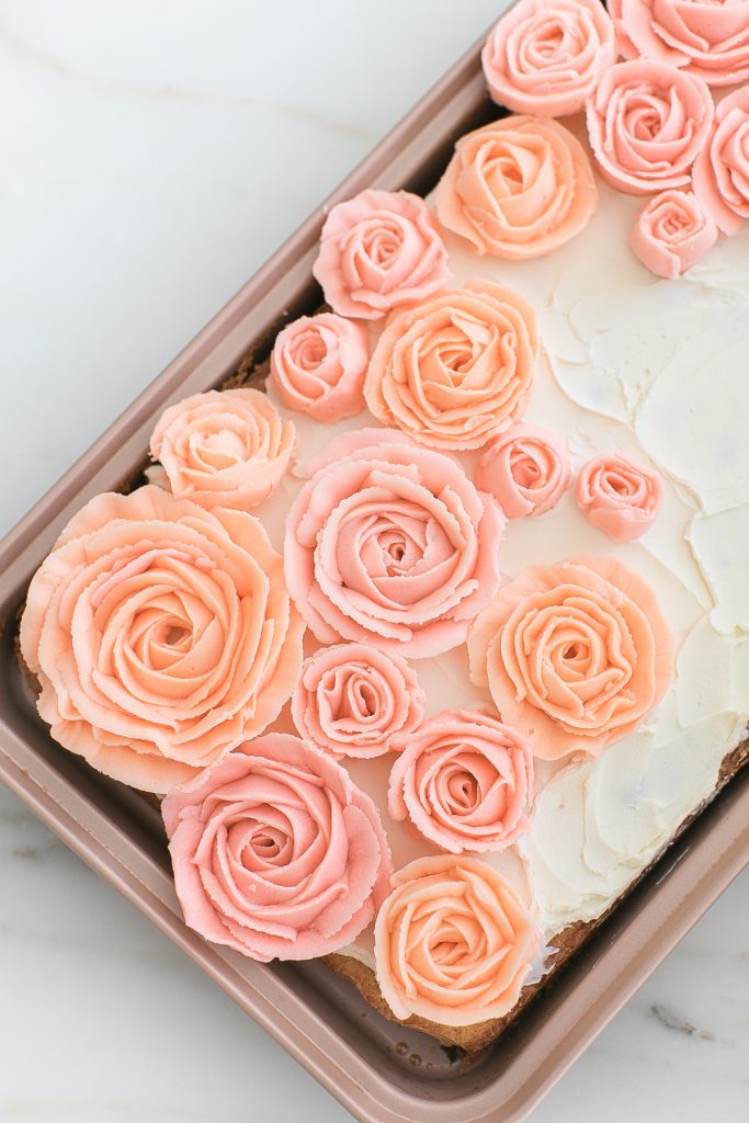 pink buttercream roses on sheet cake
