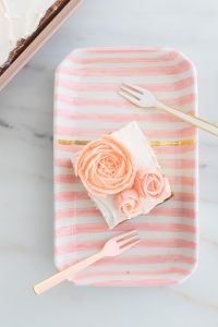 Buttercream roses on striped cake plate