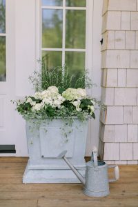 planter with watering can in front