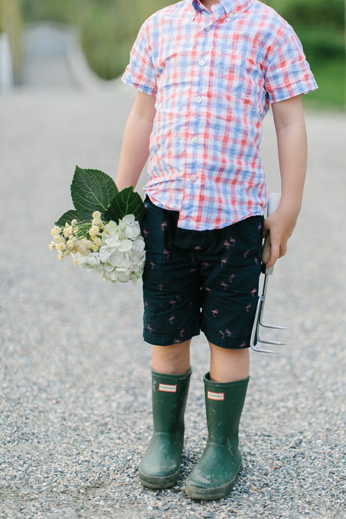 little boy, boots and flowers