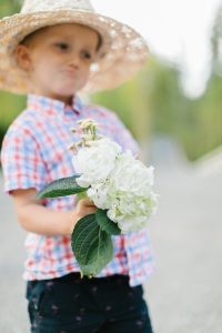 little boy holding flowers